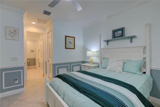 6005 Bella Rosa Ln, Vero Beach, FL 32966 - bedroom featuring wainscoting, crown molding, light tile patterned floors, and ceiling fan