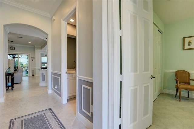 6005 Bella Rosa Ln, Vero Beach, FL 32966 - hall with arched walkways, crown molding, light tile patterned flooring, baseboards, and recessed lighting