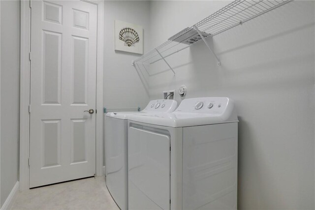 6005 Bella Rosa Ln, Vero Beach, FL 32966 - washroom with washer and clothes dryer and baseboards