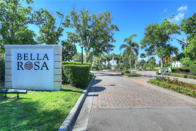 6005 Bella Rosa Ln, Vero Beach, FL 32966 - view of asphalt road featuring street lighting, traffic signs, and curbs