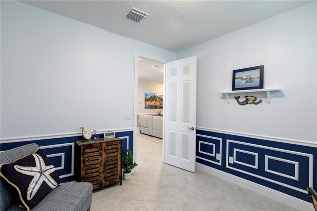 6005 Bella Rosa Ln, Vero Beach, FL 32966 - living area with wainscoting and tile patterned flooring