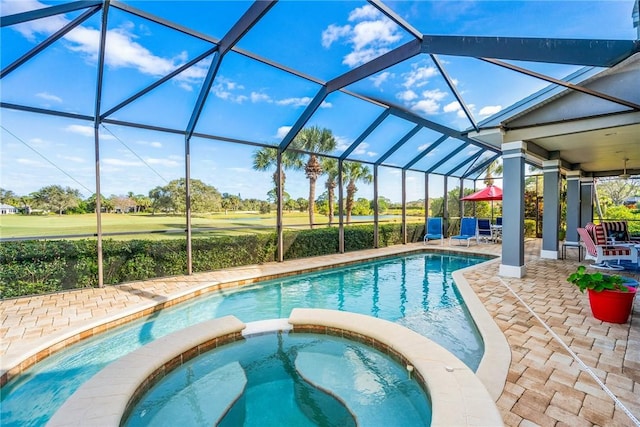 view of pool with an in ground hot tub, glass enclosure, and a patio area