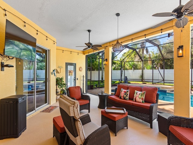 view of patio with outdoor lounge area, ceiling fan, a fenced in pool, and glass enclosure