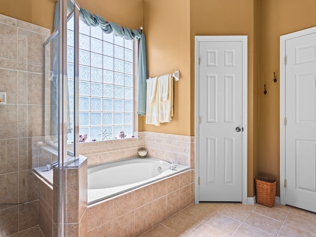 bathroom featuring shower with separate bathtub, tile patterned floors, and a healthy amount of sunlight