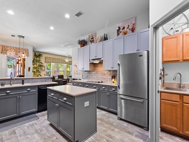 kitchen with hanging light fixtures, black appliances, sink, and gray cabinetry