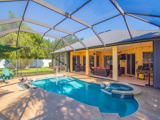 view of swimming pool featuring glass enclosure, ceiling fan, an in ground hot tub, and a patio area