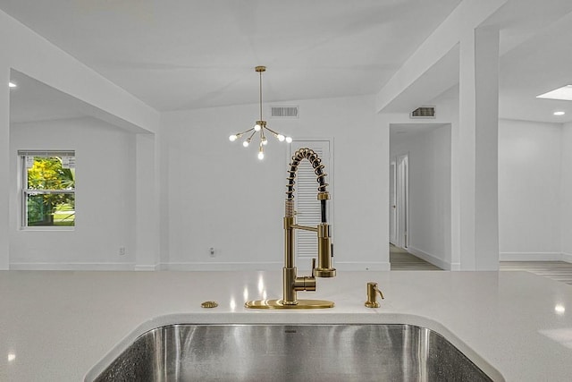 details with sink and a chandelier