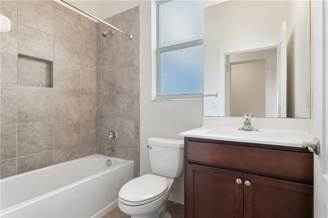 full bathroom featuring vanity, toilet, and tiled shower / bath