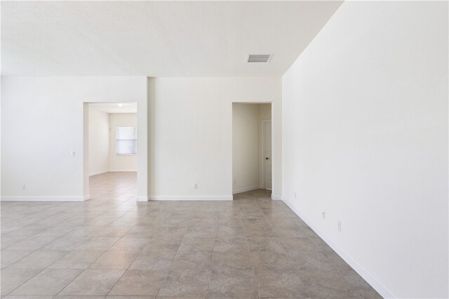 spare room featuring light tile patterned floors