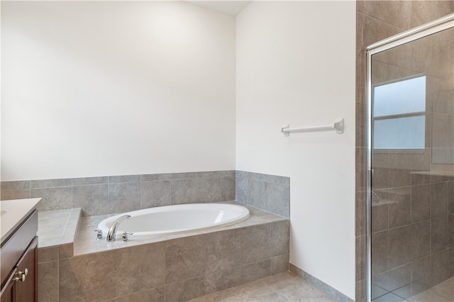 bathroom with tile patterned flooring, vanity, and independent shower and bath