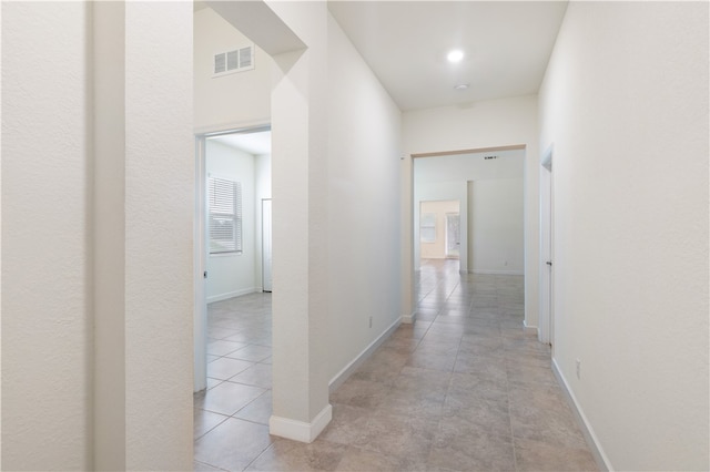 hallway with light tile patterned floors