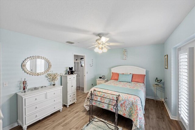 bedroom with light hardwood / wood-style floors and ceiling fan