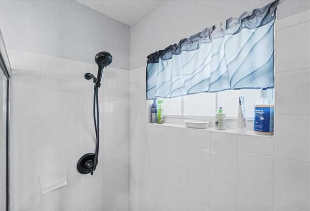 bathroom with tiled shower