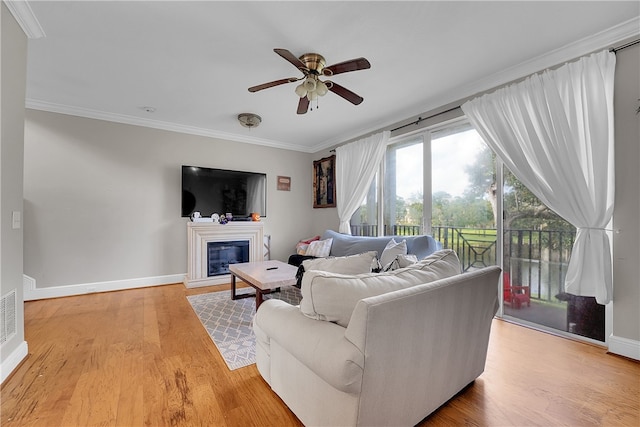 living room with ceiling fan, light hardwood / wood-style flooring, and ornamental molding