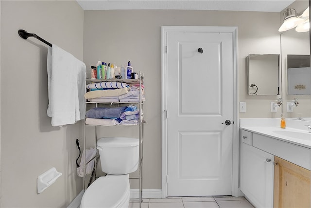 bathroom featuring vanity, tile patterned floors, and toilet