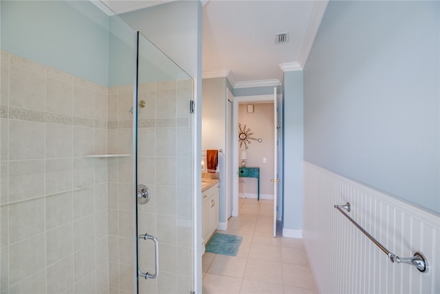 bathroom with ornamental molding, tile patterned flooring, vanity, and a shower with door