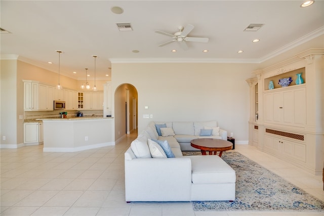 living room featuring light tile patterned flooring, ceiling fan with notable chandelier, and crown molding