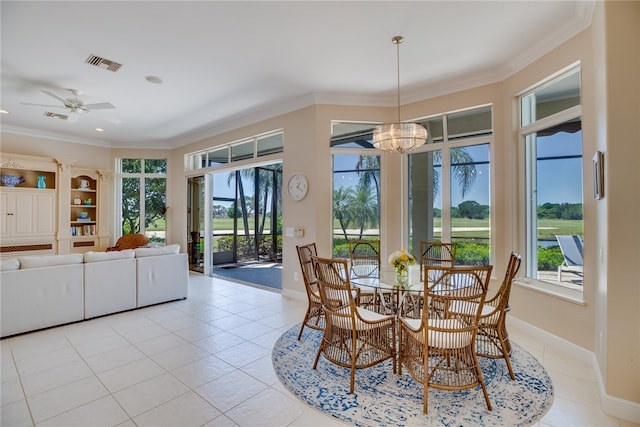 dining space with light tile patterned flooring, ceiling fan with notable chandelier, and crown molding