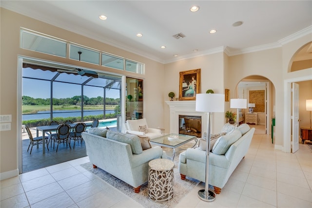 living room with light tile patterned floors and crown molding