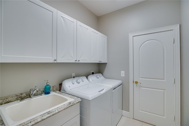 laundry area featuring cabinets, separate washer and dryer, sink, and light tile patterned flooring