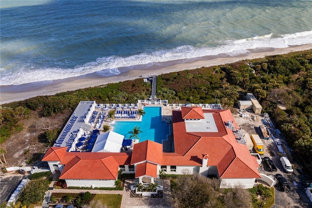 birds eye view of property with a water view and a view of the beach