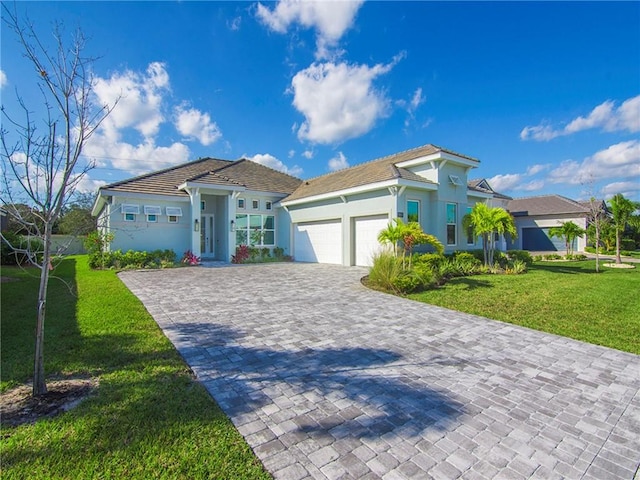 view of front facade with a front yard and a garage