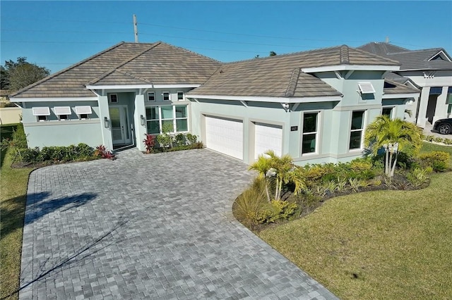 view of front of home featuring a front yard and a garage