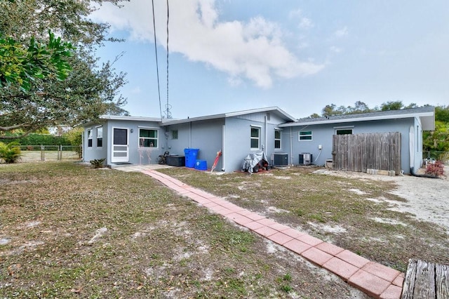 rear view of property featuring central AC unit