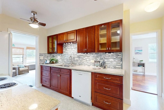 kitchen featuring sink, white appliances, ceiling fan, light stone countertops, and backsplash