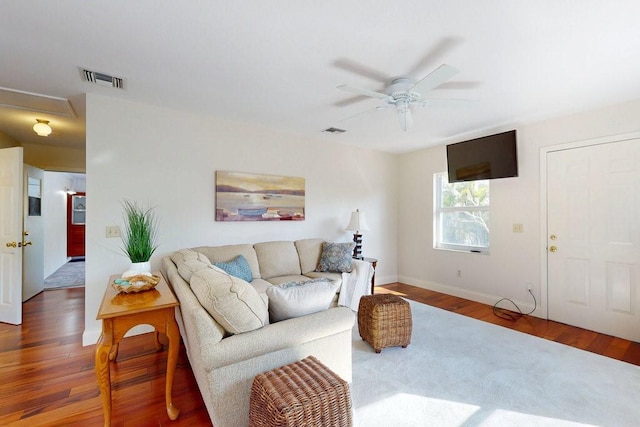 living room with wood-type flooring and ceiling fan