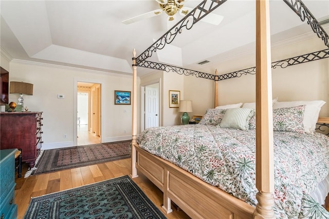 1250 W Southwinds Blvd Unit 310, Vero Beach, FL 32963 - bedroom with a raised ceiling, wood finished floors, a ceiling fan, and ornamental molding