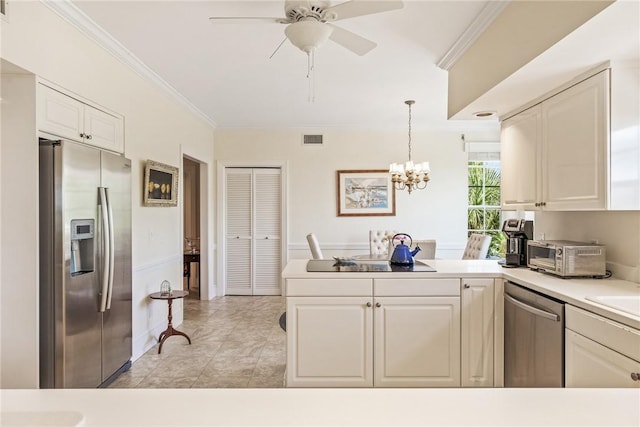 1250 W Southwinds Blvd Unit 310, Vero Beach, FL 32963 - kitchen with stainless steel appliances, a peninsula, ornamental molding, white cabinetry, and a chandelier