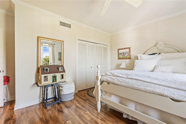 1250 W Southwinds Blvd Unit 310, Vero Beach, FL 32963 - bedroom featuring ornamental molding, wood finished floors, a closet, and a ceiling fan