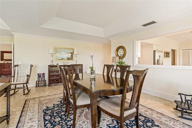 1250 W Southwinds Blvd Unit 310, Vero Beach, FL 32963 - dining space with a tray ceiling, crown molding, and light tile patterned floors