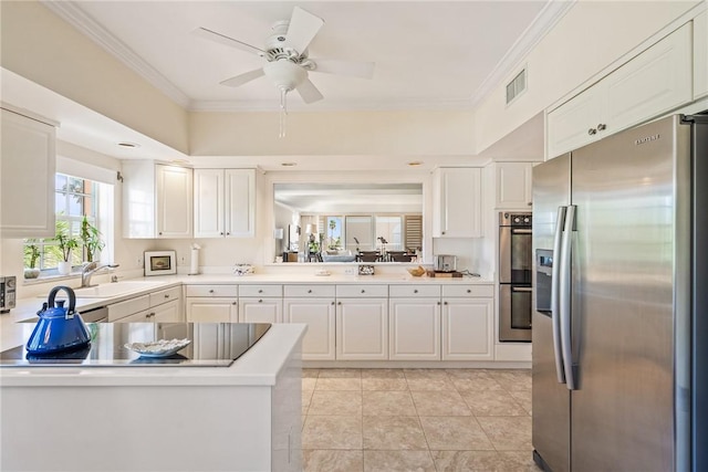 1250 W Southwinds Blvd Unit 310, Vero Beach, FL 32963 - kitchen with appliances with stainless steel finishes, light countertops, white cabinets, crown molding, and ceiling fan