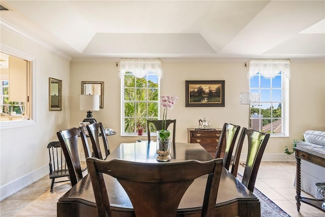 1250 W Southwinds Blvd Unit 310, Vero Beach, FL 32963 - dining room featuring a raised ceiling, light tile patterned flooring, and crown molding