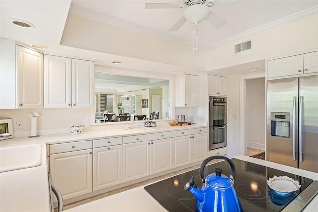 1250 W Southwinds Blvd Unit 310, Vero Beach, FL 32963 - kitchen featuring stainless steel appliances, white cabinetry, light countertops, ceiling fan, and ornamental molding
