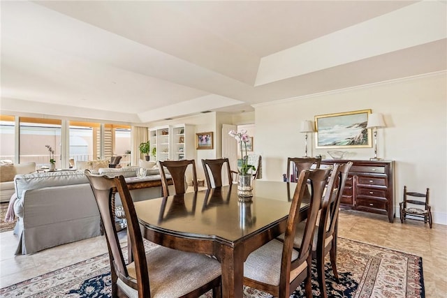 1250 W Southwinds Blvd Unit 310, Vero Beach, FL 32963 - dining space with a tray ceiling and baseboards