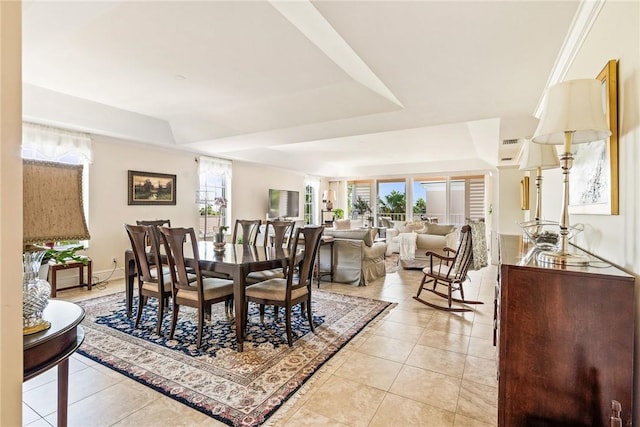 1250 W Southwinds Blvd Unit 310, Vero Beach, FL 32963 - dining space featuring a raised ceiling and light tile patterned flooring
