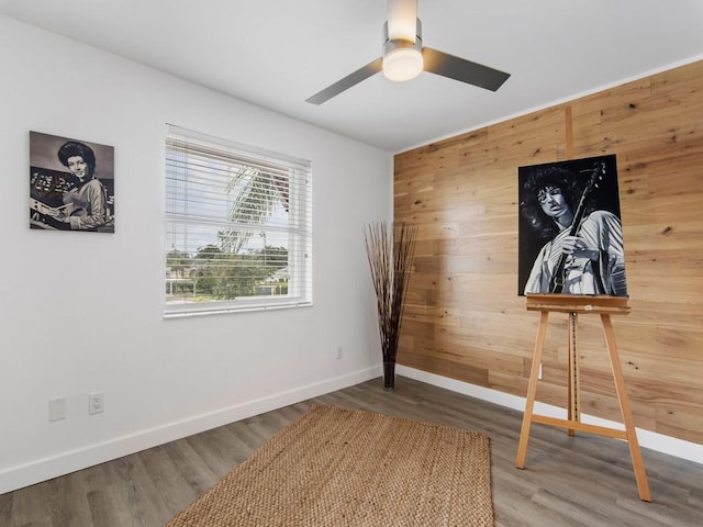 540 Grove Isle Cir Unit 207, Vero Beach, FL 32962 - unfurnished bedroom featuring wood walls, baseboards, wood finished floors, and ceiling fan