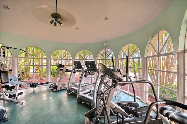 exercise room featuring ceiling fan, plenty of natural light, and a textured ceiling