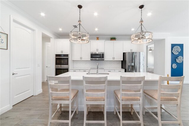 6354 Arcadia Sq, Vero Beach, FL 32966 - kitchen featuring appliances with stainless steel finishes, a chandelier, a sink, decorative backsplash, and crown molding