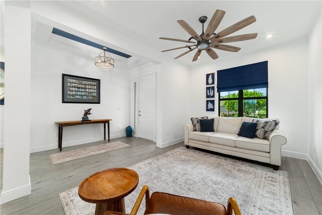 6354 Arcadia Sq, Vero Beach, FL 32966 - living area featuring wood finished floors, ceiling fan, a chandelier, and baseboards