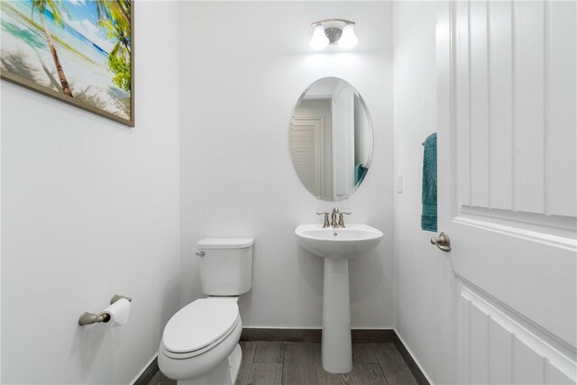 6354 Arcadia Sq, Vero Beach, FL 32966 - bathroom with toilet, baseboards, a sink, and wood finished floors