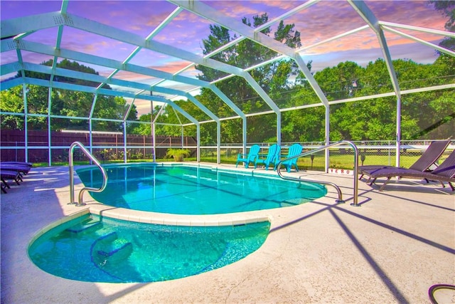 955 28th Ave, Vero Beach, FL 32960 - pool at dusk featuring a fenced backyard, a patio, and glass enclosure