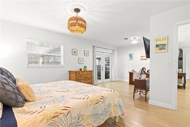 955 28th Ave, Vero Beach, FL 32960 - bedroom with light wood-type flooring, french doors, access to outside, and baseboards
