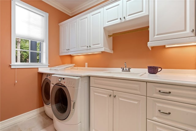 clothes washing area featuring crown molding, washer and clothes dryer, light tile patterned floors, cabinets, and sink