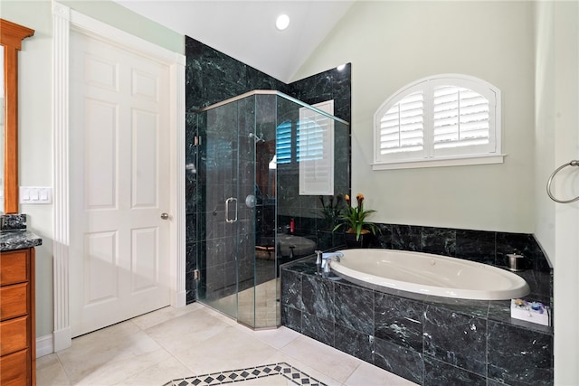 bathroom with independent shower and bath, vanity, vaulted ceiling, and tile patterned floors