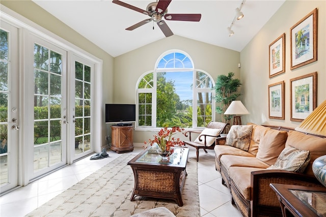 tiled living room featuring ceiling fan, plenty of natural light, track lighting, and vaulted ceiling