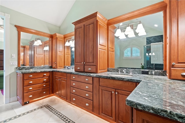 bathroom featuring walk in shower, vanity, vaulted ceiling, and tile patterned flooring